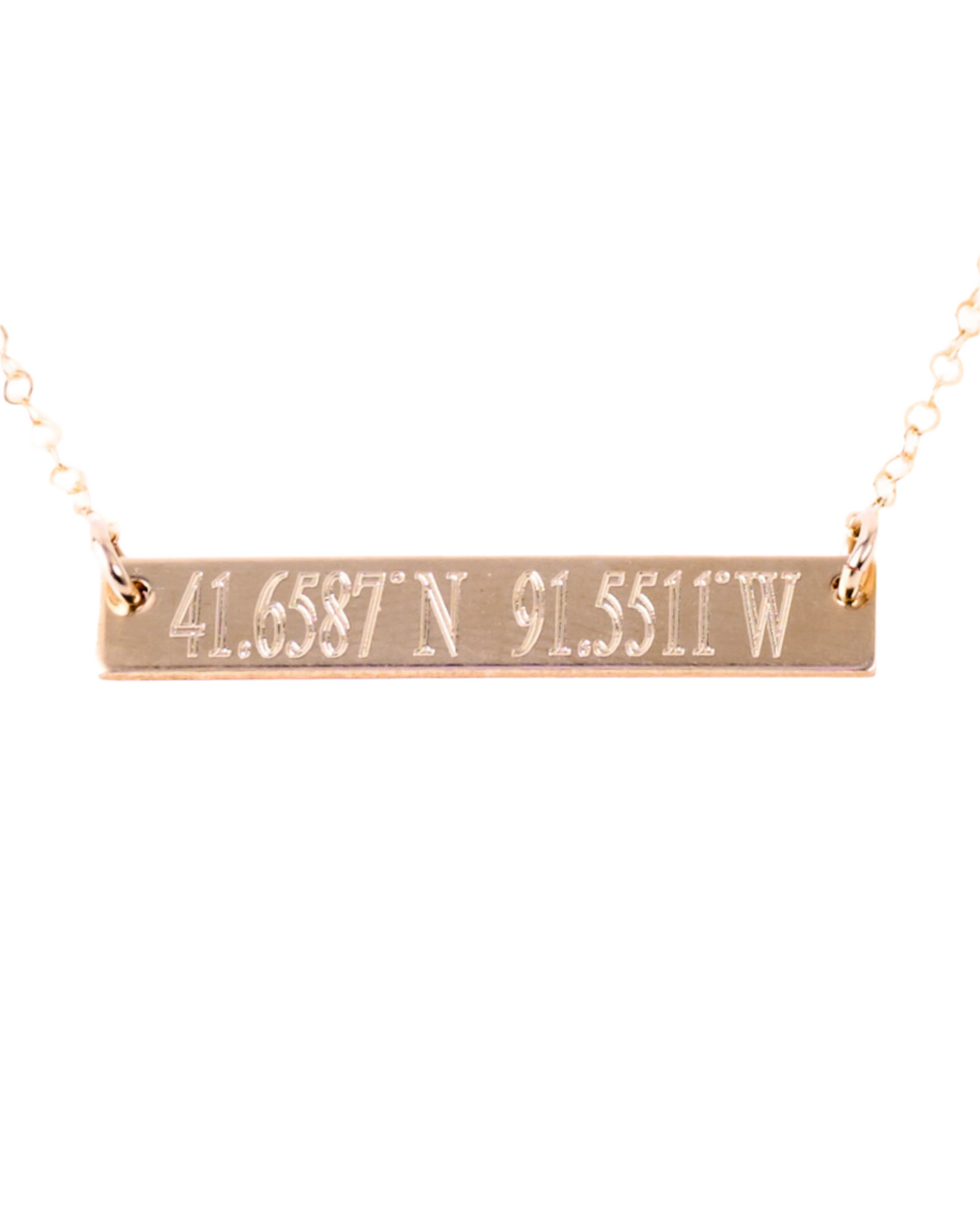 A gold-filled rectangle bar necklace with coordinates engraved on it, displayed on a white background.