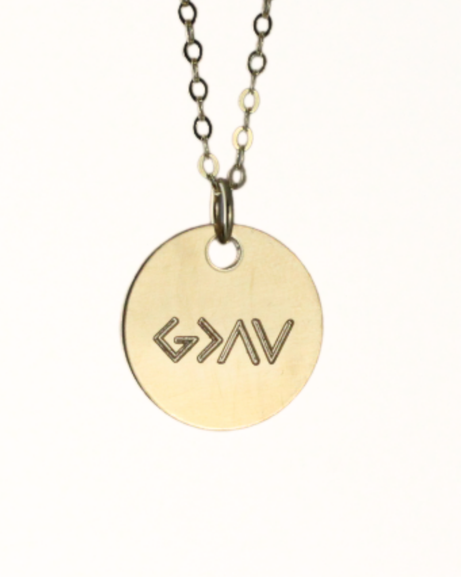 A gold-filled disc necklace with the inscription 'G>^v' on it, suspended from a chain.