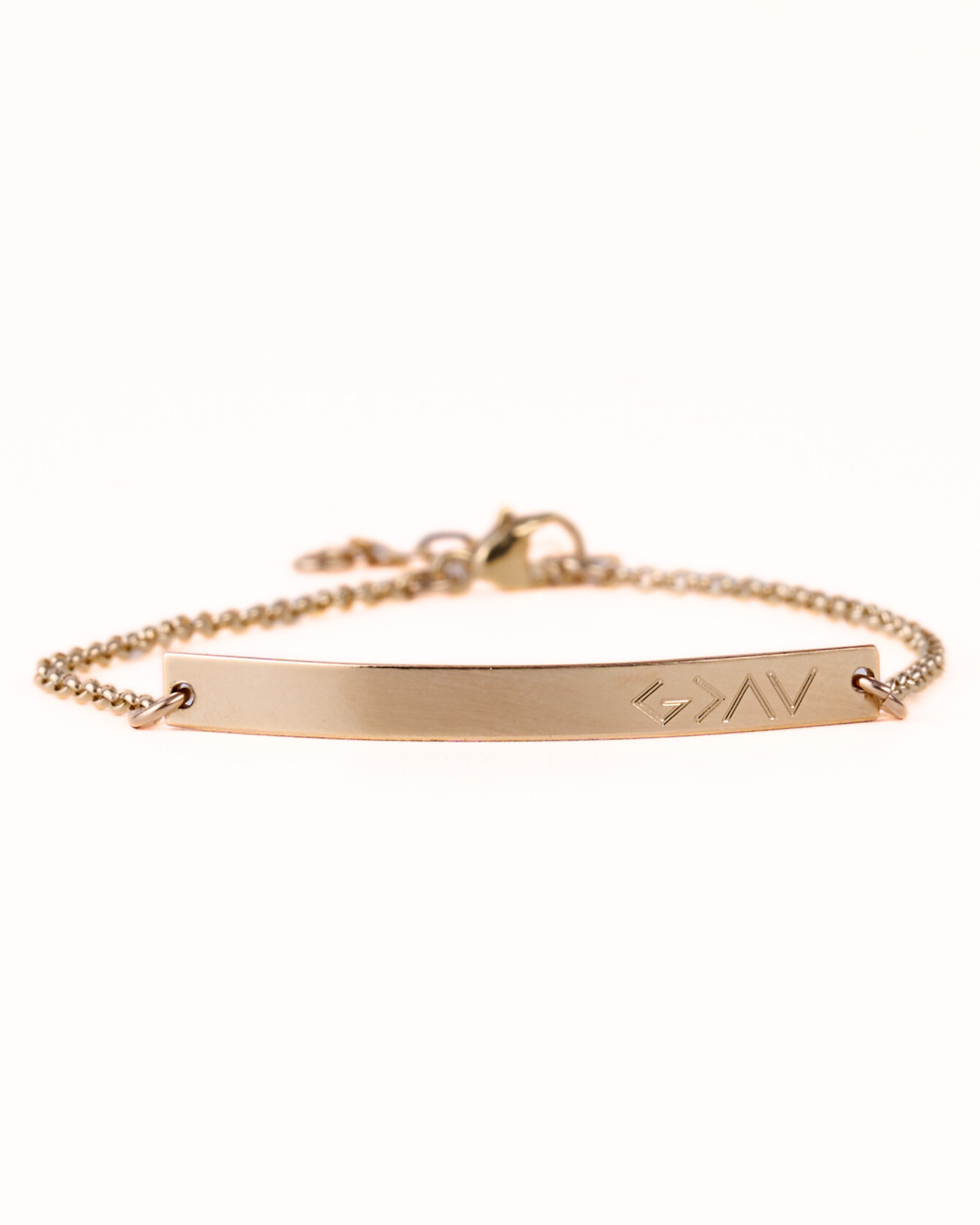 A gold-filled skinny bar bracelet with a chain link, engraved with 'GOD IS GREATER' on the bar surface.