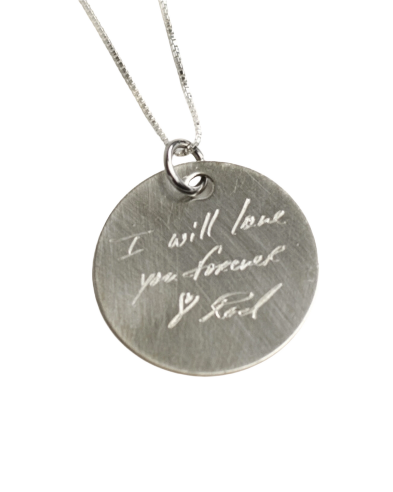 A custom handwriting disc necklace with the engraving 'I will love you forever' on a silver chain.