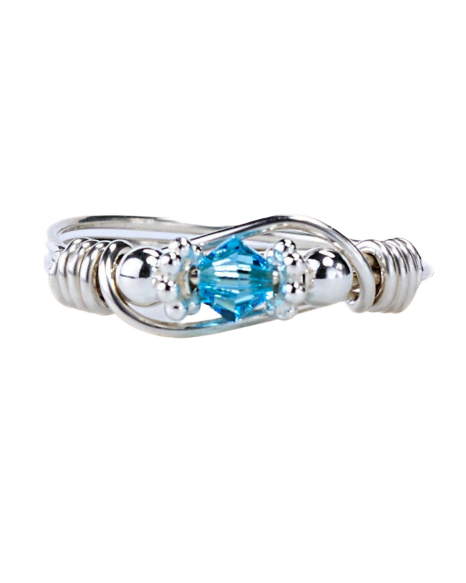 A sterling silver ring with a central blue Swarovski crystal, surrounded by smaller clear crystals, wire, and beads.