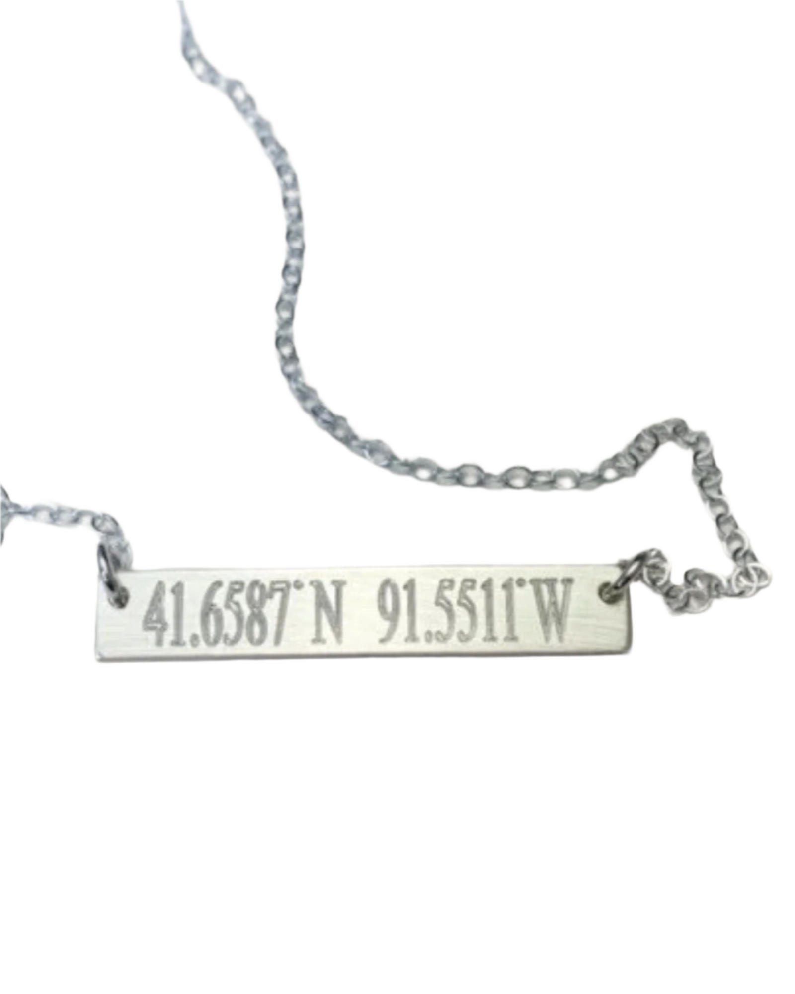 A necklace with a bar pendant engraved with coordinates '41.6587 N 91.5511 W' on a chain, displayed on a white background.